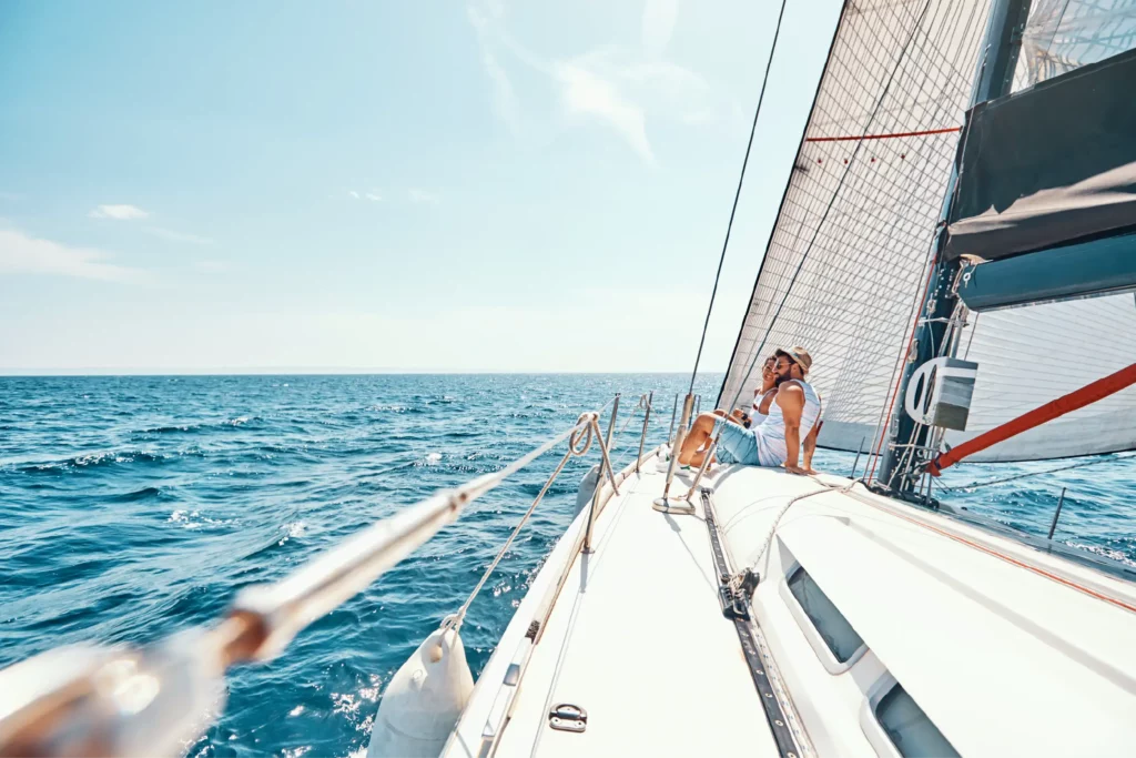 Couple on sailing yacht on a pacific coast excursion booked with acx travel.