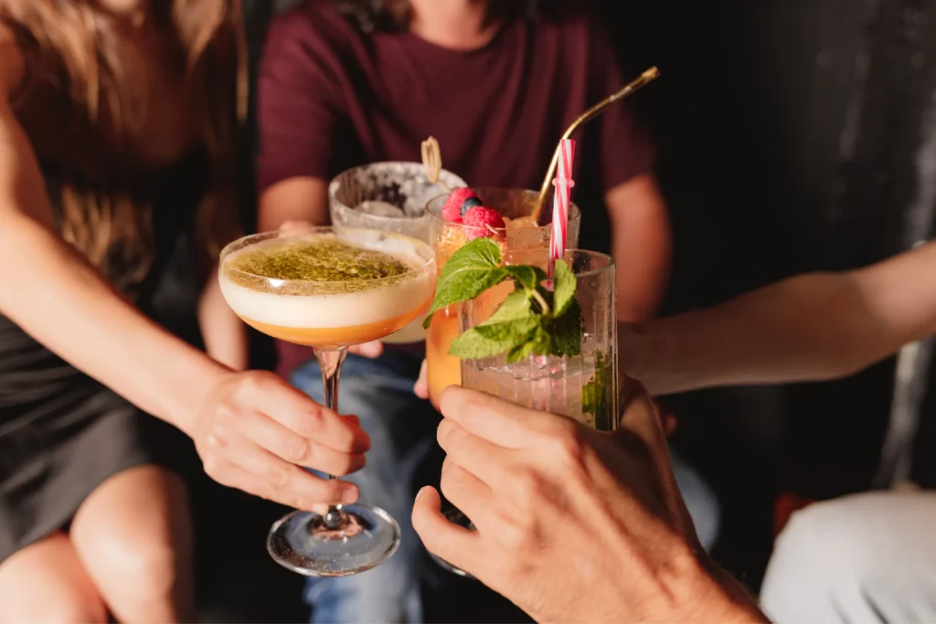 Friends enjoying cocktails together on trip booked with acx travel.