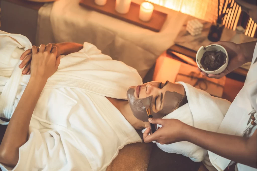 Woman enjoying spa treatment on trip booked with acx travel.
