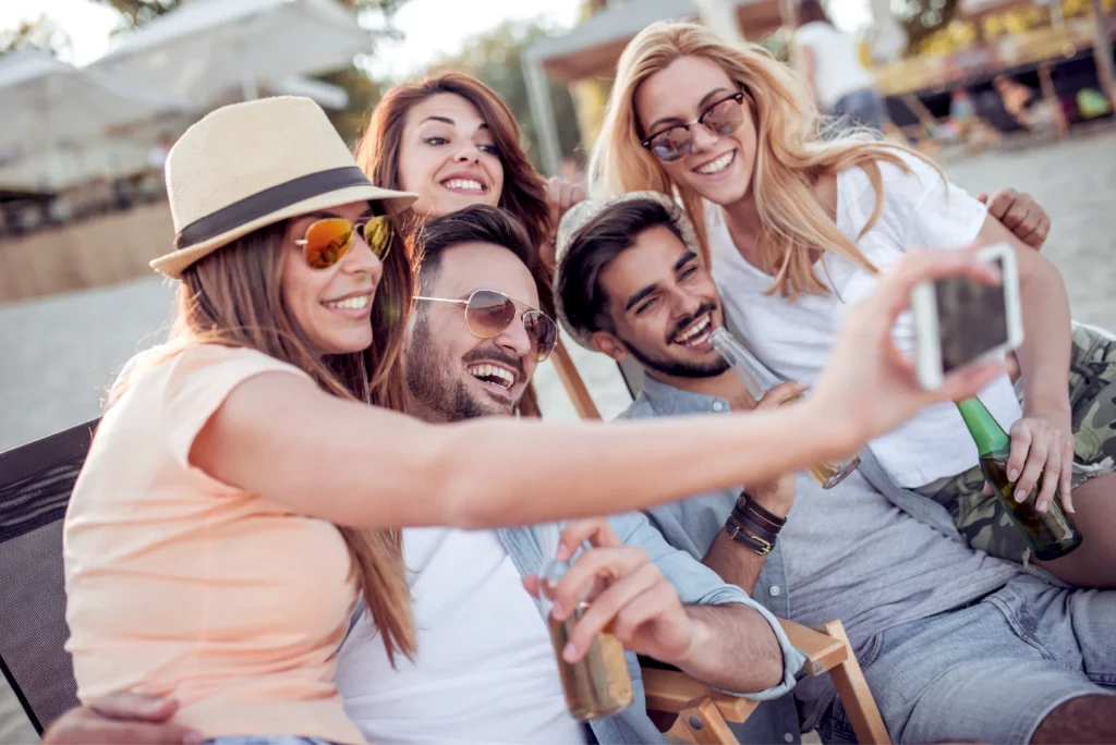 Group of friends taking a selfie on a vacation they booked with acx travel.