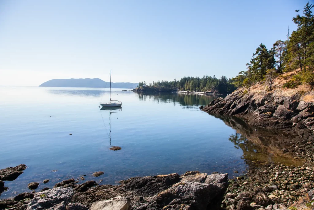 Sail boat anchored along coast of orcas island in the san juan islands in washington.