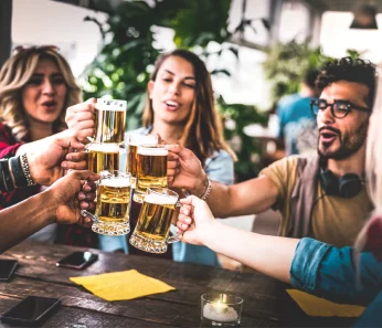 Excited group of friends on a craft beer tour booked with acx travel.