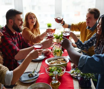 Friends sharing dinner on an excursion book with acx travel.